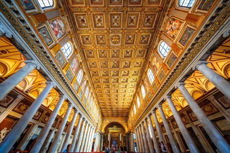 Stunning view of the ornate ceiling and architecture of a basilica in Rome, Italy.